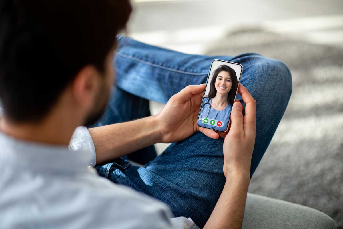 cropped of man using cellphone at home talking